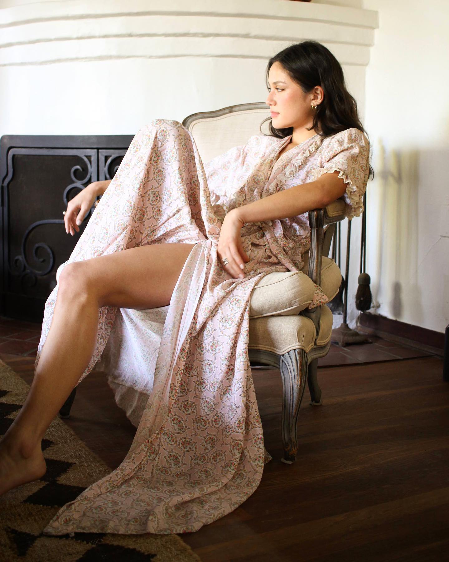 Blossom Vintage girl in white wedding dress next to fireplace