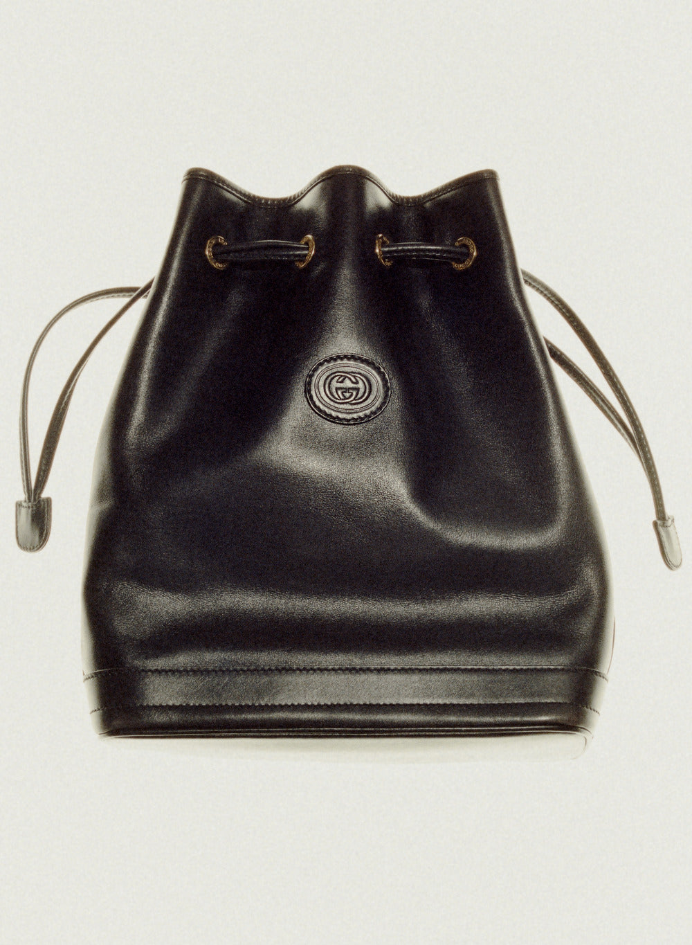 vintage essential black gucci leather bag on white background