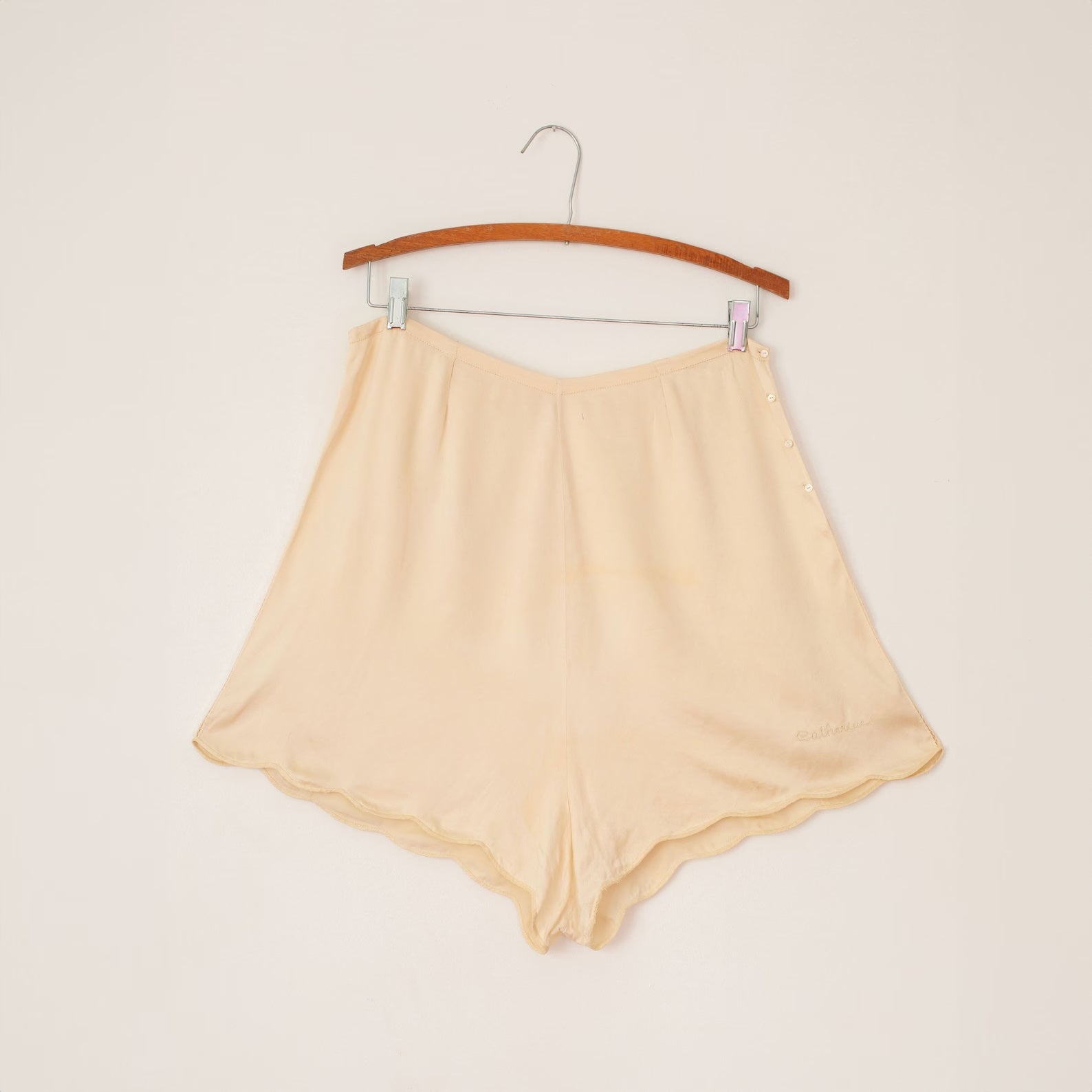 cream silk tap shorts. "catherine" embroidered on the leg. the side seams are decoratively hand sewn.