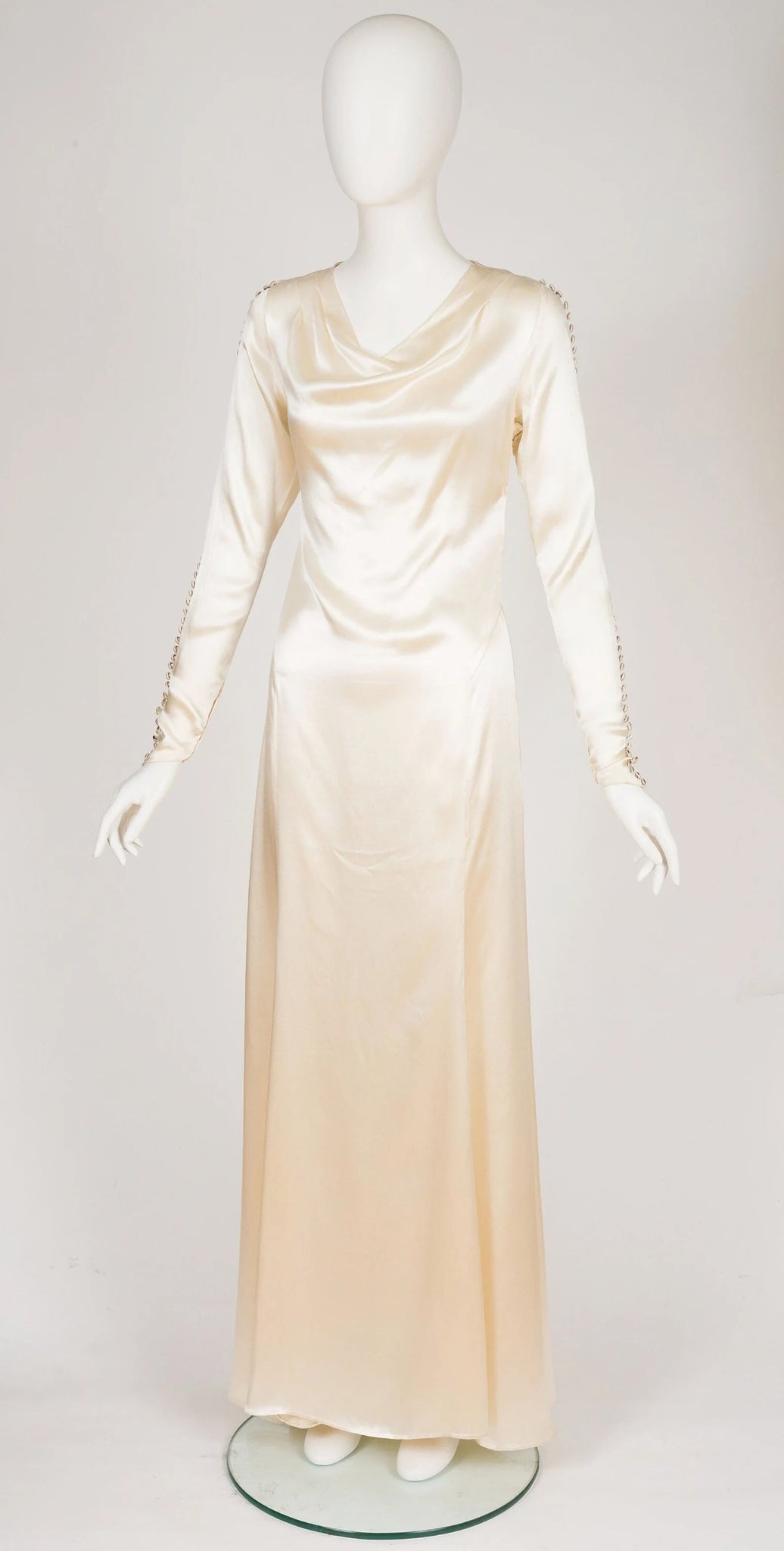 Ivory Liquid Silk Satin Long Sleeve Weighted Neckline Wedding Dress fastens with hook-and-eyes up the left side and snaps at the cuffs